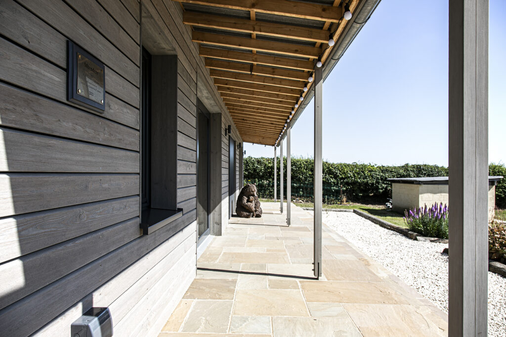 External photo of Sandall House showing a shaded porch area giving shading to the front windows.